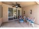 Inviting outdoor patio with a ceiling fan, comfortable seating, and view of the sparkling pool at 411 N Cordoba Pl, Chandler, AZ 85226