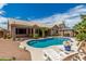 Resort-style backyard showcasing a sparkling pool, landscaped grounds, and outdoor seating for relaxation at 411 N Cordoba Pl, Chandler, AZ 85226