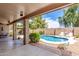 Backyard featuring a refreshing in-ground pool, lush landscaping, and ample patio space for entertaining at 411 N Cordoba Pl, Chandler, AZ 85226