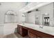 Bright bathroom featuring dual sinks, a large mirror, and plenty of storage space at 411 N Cordoba Pl, Chandler, AZ 85226