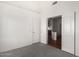Bright bedroom with neutral carpet and doorway to the living area at 411 N Cordoba Pl, Chandler, AZ 85226