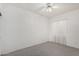 Bright bedroom with neutral carpet and window with simple white curtains at 411 N Cordoba Pl, Chandler, AZ 85226
