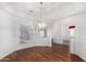 Bright dining room with hardwood floors, white walls, and an elegant chandelier at 411 N Cordoba Pl, Chandler, AZ 85226