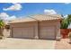 Lovely single-story home featuring desert landscaping, a tile roof, and a two-car garage at 411 N Cordoba Pl, Chandler, AZ 85226