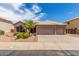 Charming single-story home with a three-car garage, desert landscaping, and a tile roof at 411 N Cordoba Pl, Chandler, AZ 85226