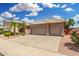Lovely single-story home featuring desert landscaping, a tile roof, and a three-car garage at 411 N Cordoba Pl, Chandler, AZ 85226
