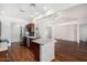 Open concept kitchen and living space featuring marble countertops, wood cabinets, and stainless appliances at 411 N Cordoba Pl, Chandler, AZ 85226