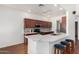 Kitchen featuring marble countertops, wood cabinets, tile backsplash, and stainless steel appliances at 411 N Cordoba Pl, Chandler, AZ 85226