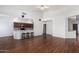 Open-concept space with wood floors, breakfast bar and stools, and an adjacent kitchen at 411 N Cordoba Pl, Chandler, AZ 85226