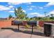 Community barbecue grills with a brick wall surround and trash receptacle for convenient outdoor cooking at 4156 E Jesse St, Gilbert, AZ 85295