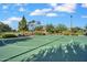 Community basketball court featuring green surface, basketball hoop, and surrounding landscaping at 4156 E Jesse St, Gilbert, AZ 85295