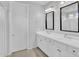 This bathroom features a double sink vanity with matching mirrors and bright lighting at 4156 E Jesse St, Gilbert, AZ 85295