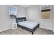 This bedroom features neutral walls, carpet, and a queen bed between two windows at 4156 E Jesse St, Gilbert, AZ 85295