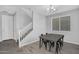 Modern dining area with a stylish table, staircase, and a large window for natural light at 4156 E Jesse St, Gilbert, AZ 85295