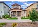 Charming two-story home with a covered porch, manicured lawn, and beautiful landscaping at 4156 E Jesse St, Gilbert, AZ 85295
