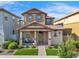 Charming two-story home featuring a cozy front porch and well-manicured landscaping with lush green grass at 4156 E Jesse St, Gilbert, AZ 85295