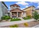 Inviting two-story home with a charming front porch, complemented by well-maintained landscaping and vibrant flowers at 4156 E Jesse St, Gilbert, AZ 85295