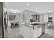Modern kitchen with stainless steel appliances, a kitchen island with a farmhouse sink, and an adjacent dining area at 4156 E Jesse St, Gilbert, AZ 85295