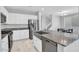 Bright kitchen featuring stainless steel appliances, white cabinets, a large island, and a view of the dining area at 4156 E Jesse St, Gilbert, AZ 85295