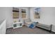 Bright loft features neutral walls and carpet, windows, a white shelf, and modular seating at 4156 E Jesse St, Gilbert, AZ 85295