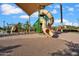 Community playground with covered slide, climbing structures, and soft landing surface at 4156 E Jesse St, Gilbert, AZ 85295