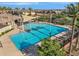 Community pool area featuring a large pool, lounge chairs, and shaded areas at 4156 E Jesse St, Gilbert, AZ 85295