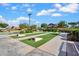 Community shuffleboard court featuring manicured grass, concrete borders, benches, and lush landscaping at 4156 E Jesse St, Gilbert, AZ 85295