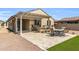 Spacious backyard with covered patio, built-in bar, and outdoor dining area at 41769 W Canasta Ln, Maricopa, AZ 85138
