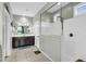A modern bathroom with sleek fixtures, a glass-enclosed shower, and a view of the double sink vanity at 41769 W Canasta Ln, Maricopa, AZ 85138
