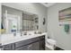 Well-lit bathroom featuring a spacious vanity, toilet, and a shower with a curtain at 41769 W Canasta Ln, Maricopa, AZ 85138