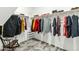 A well-organized walk-in closet with hanging clothes and storage solutions, maximizing space at 41769 W Canasta Ln, Maricopa, AZ 85138