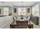 A charming dining room featuring a wooden table with seating for eight and a decorative light fixture at 41769 W Canasta Ln, Maricopa, AZ 85138
