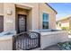 Inviting front porch with decorative security gate, courtyard wall and large window at 41769 W Canasta Ln, Maricopa, AZ 85138