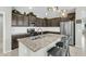 Beautiful kitchen featuring a large island, stainless appliances, and dark wood cabinetry at 41769 W Canasta Ln, Maricopa, AZ 85138