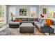 Comfortable living room featuring a large sectional sofa, ottoman, and a stylish rug adding warmth to the space at 41769 W Canasta Ln, Maricopa, AZ 85138