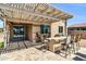 Charming covered patio featuring a built-in bar, barbecue, and string lights for outdoor entertainment at 41769 W Canasta Ln, Maricopa, AZ 85138