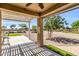 Inviting covered patio with views of landscaped backyard, blending comfort with serene outdoor ambiance at 41769 W Canasta Ln, Maricopa, AZ 85138