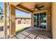 Covered patio with ceiling fan and sliding glass doors offering seamless indoor-outdoor living and backyard access at 41769 W Canasta Ln, Maricopa, AZ 85138