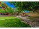 Serene backyard featuring an adirondack seating area with rock features nestled among the lush landscaping at 4317 E Yucca St, Phoenix, AZ 85028