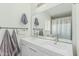 Bathroom featuring double sinks, a large mirror, and towel racks, complemented by neutral decor at 4317 E Yucca St, Phoenix, AZ 85028
