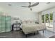 Bright bedroom featuring tile floors, ceiling fan, and a sliding glass door to the outdoor pool area at 4317 E Yucca St, Phoenix, AZ 85028