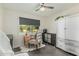 Stylish bedroom featuring tile flooring, an accent chair, and a window overlooking the backyard at 4317 E Yucca St, Phoenix, AZ 85028