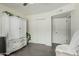 Bedroom with tile flooring, double closets, and an armoire, accented by potted plants at 4317 E Yucca St, Phoenix, AZ 85028