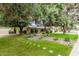 Single story home with a beautifully landscaped front yard with mature trees and a stone pathway at 4317 E Yucca St, Phoenix, AZ 85028