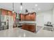Modern kitchen with stainless steel appliances, custom cabinetry, granite countertops, and stylish lighting fixtures at 4317 E Yucca St, Phoenix, AZ 85028