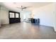 Spacious living room featuring tile floors and modern black built-ins with ceiling fan at 4317 E Yucca St, Phoenix, AZ 85028