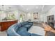 Bright, open living space featuring a stylish blue sofa, neutral decor, and seamless flow to the kitchen at 4317 E Yucca St, Phoenix, AZ 85028