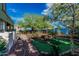 Fully fenced backyard with mature trees, artificial turf area, gravel, desert landscaping and a hot tub at 4413 E Odessa Dr, San Tan Valley, AZ 85140