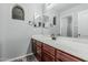 Bathroom featuring a vanity sink with a wooden cabinets, large mirror and grey accent walls at 4413 E Odessa Dr, San Tan Valley, AZ 85140