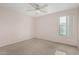 Simple bedroom with ceiling fan and window offers calm space to relax at 4413 E Odessa Dr, San Tan Valley, AZ 85140